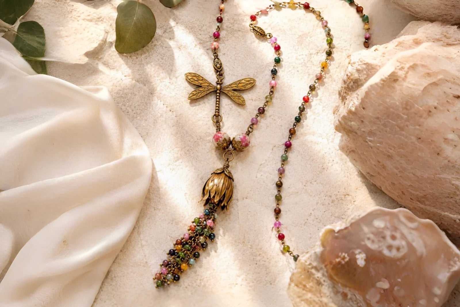 Tulipe Watermelon Tourmaline Necklace with sculptural brass tulip and dragonfly details surrounded by natural stone and ivory silk.