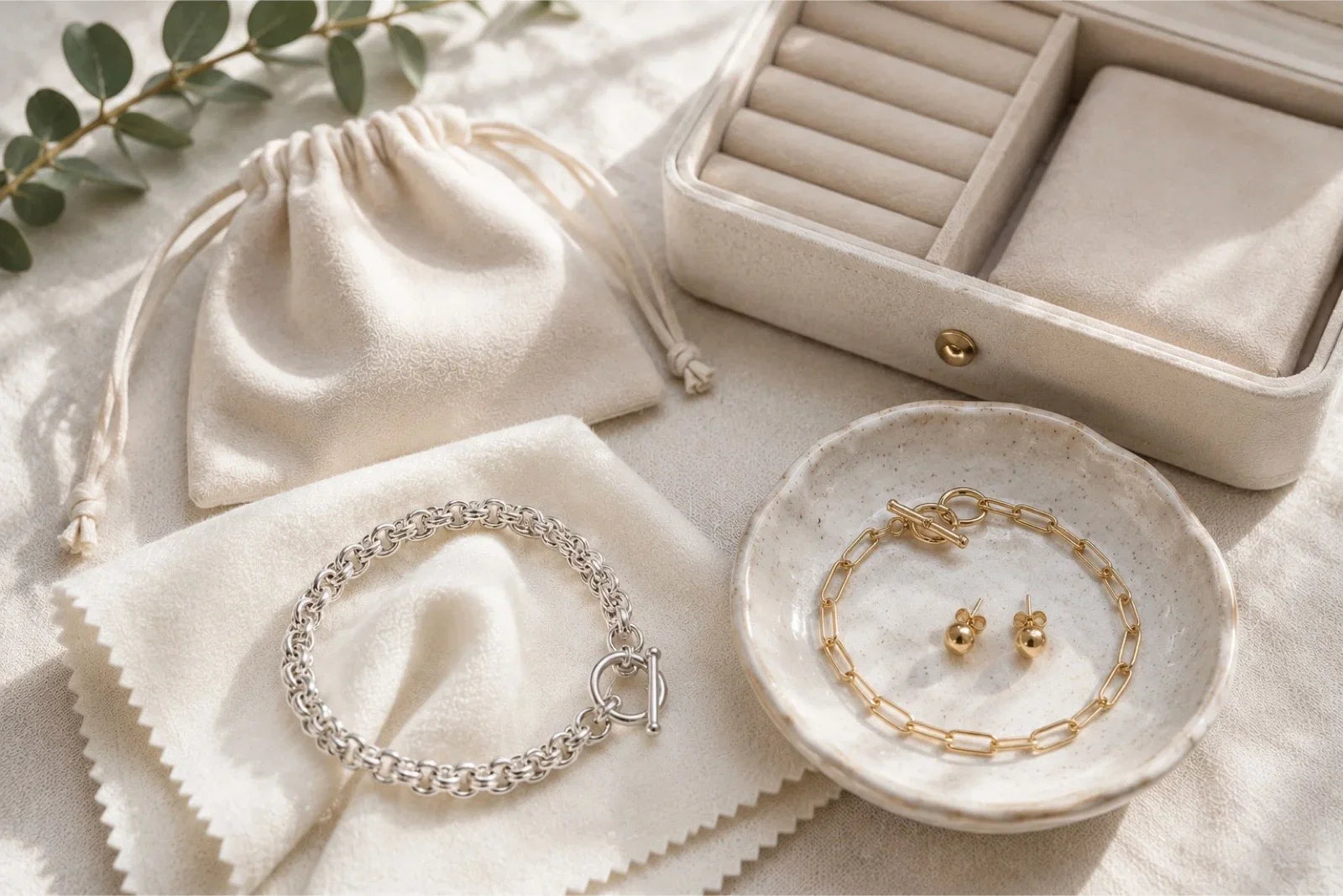 Sterling silver and gold jewellery with a soft polishing cloth, jewellery pouch and storage box illustrating proper jewellery care and storage.