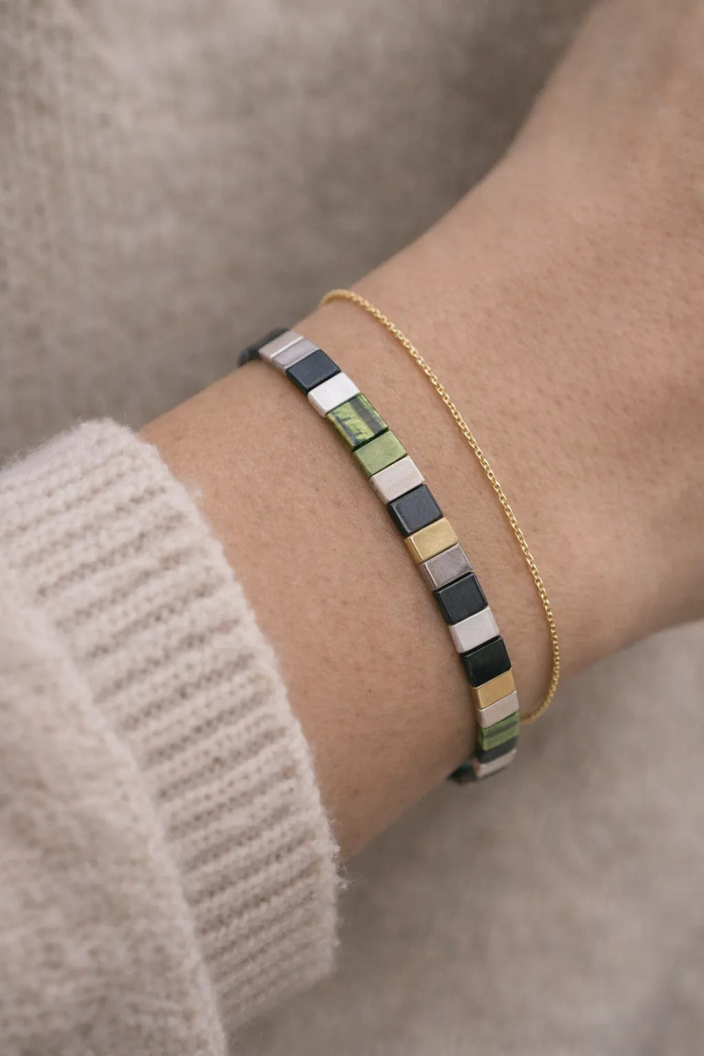 Ainsley Miyuki Tila bracelet layered with a delicate gold chain bracelet styled for effortless everyday wear