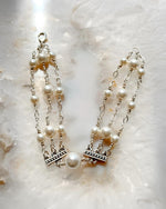 Triple strand pearl bracelet featuring Austrian crystal pearls and sterling silver detailing