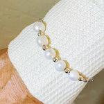 Close up of the Callie Freshwater Pearl & Sterling Silver Bracelet worn on the wrist, showcasing the natural lustre of the freshwater pearls and subtle silver accents.