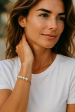 Lifestyle image of the Callie Freshwater Pearl & Sterling Silver Bracelet worn on the wrist, highlighting its timeless pearl design and refined everyday elegance.