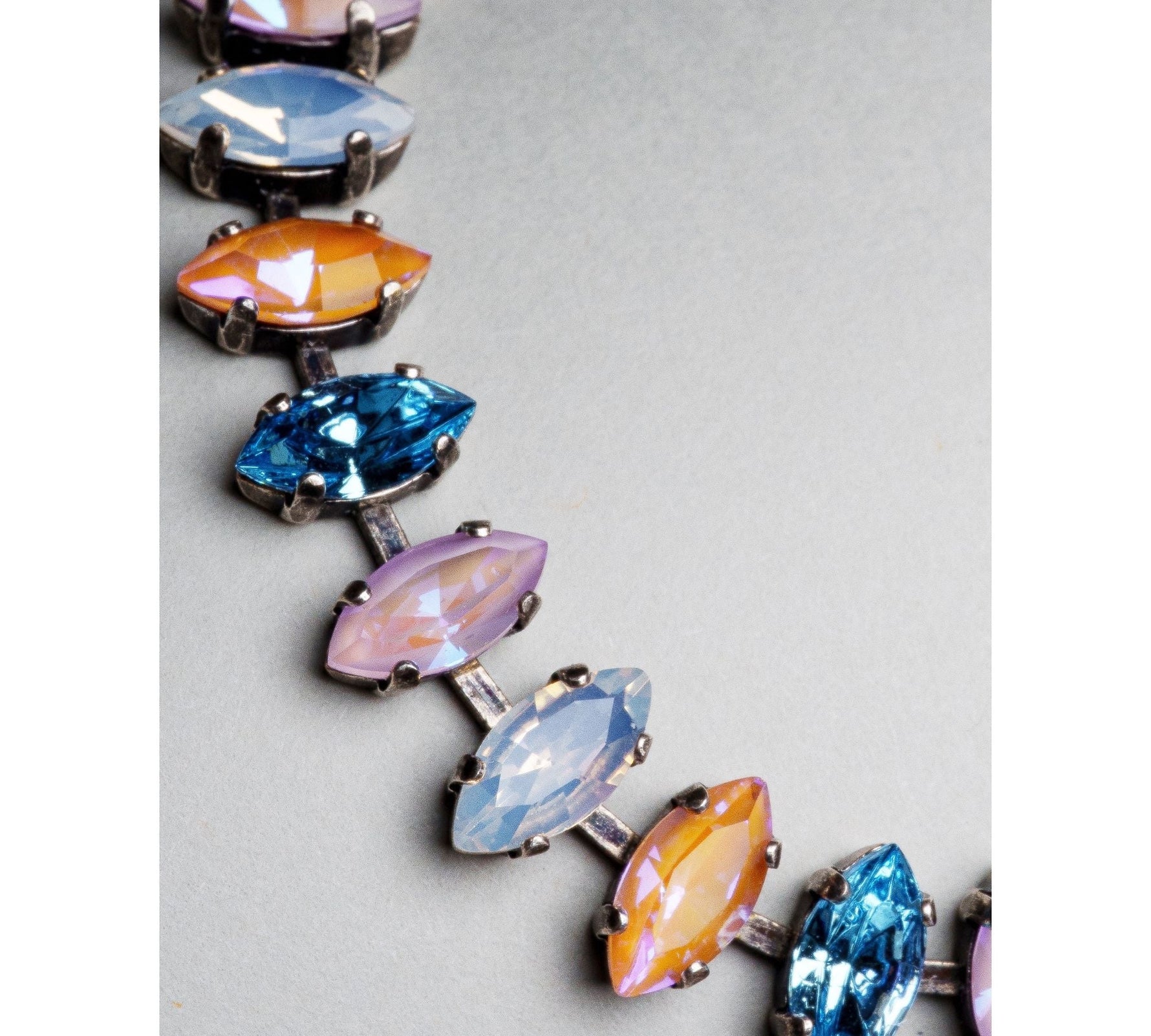 Close up of Capri bracelet showcasing marquis cut Austrian crystals in vibrant colours set in an antique silver tennis design