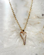 Cara Gold Heart A Necklace with pave heart pendant photographed on a crystal stone background