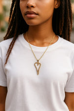 Model wearing the Cara Gold Heart A Necklace with pave heart pendant on a delicate gold chain