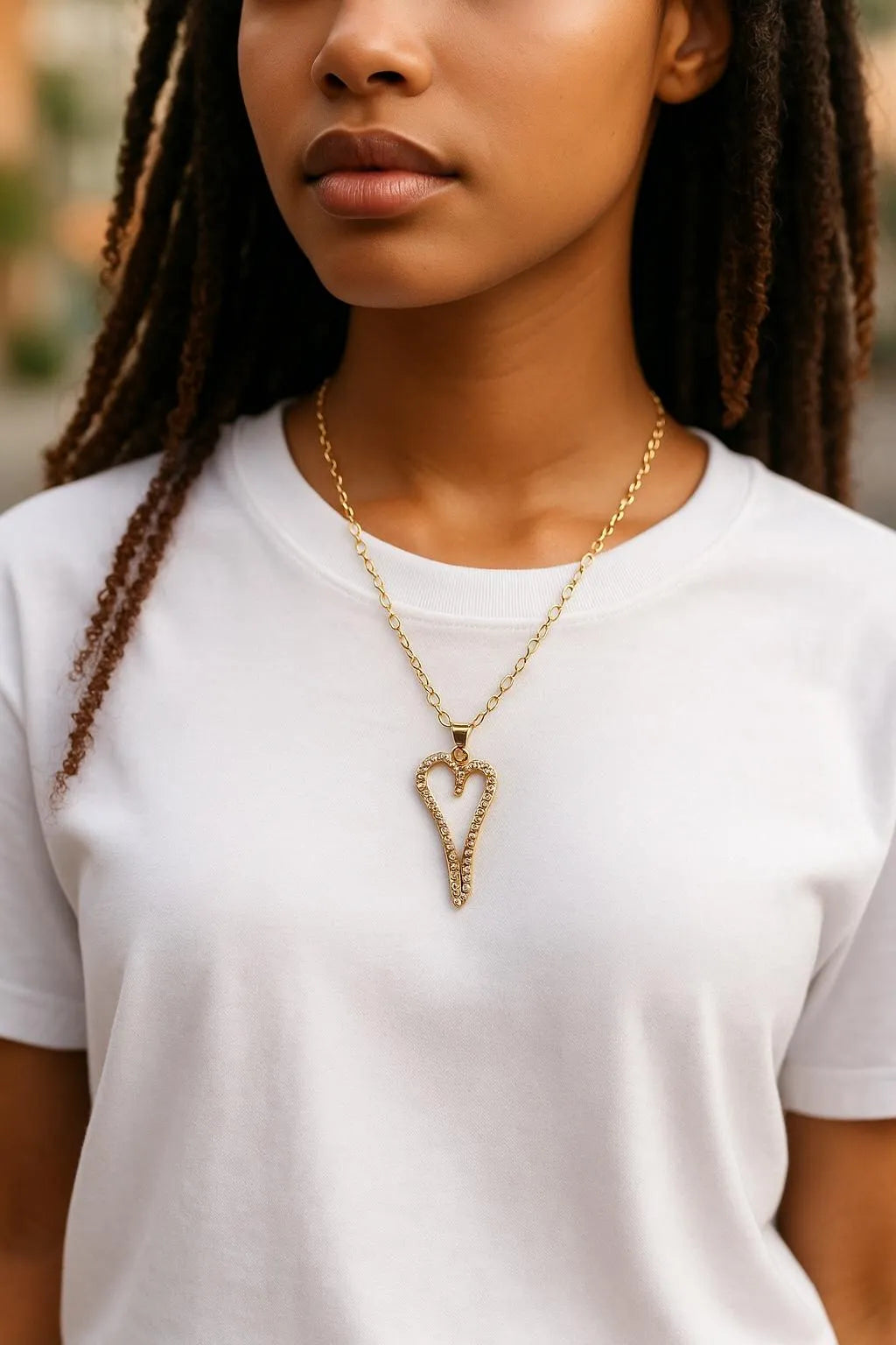 Model wearing the Cara Gold Heart A Necklace with pave heart pendant on a delicate gold chain