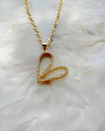 Detailed view of the Cara Gold Heart B Necklace showing pave crystal heart design