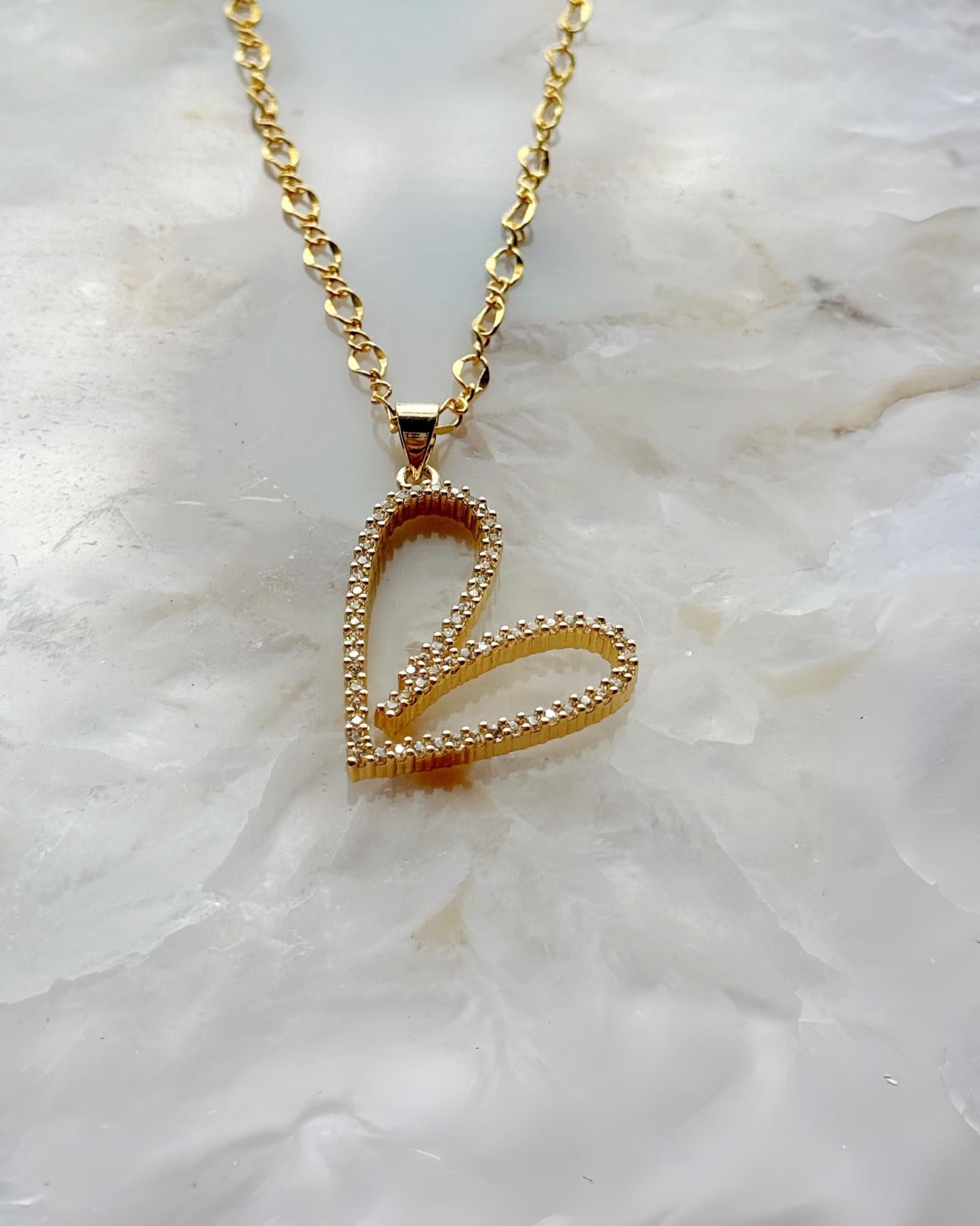 Detailed view of the Cara Gold Heart B Necklace showing pave crystal heart design