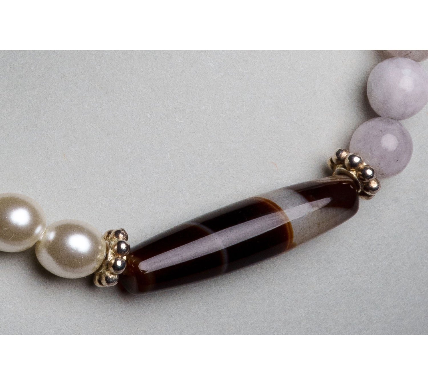 Close-up of the Elodie Bracelet highlighting the one-of-a-kind Tibetan agate focal bead framed by European crystal pearls and antique silver detailing