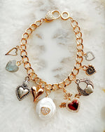 Esme charm bracelet featuring multi-metal heart charms and a sparkling micro-pavé heart clasp, handcrafted in Canada.