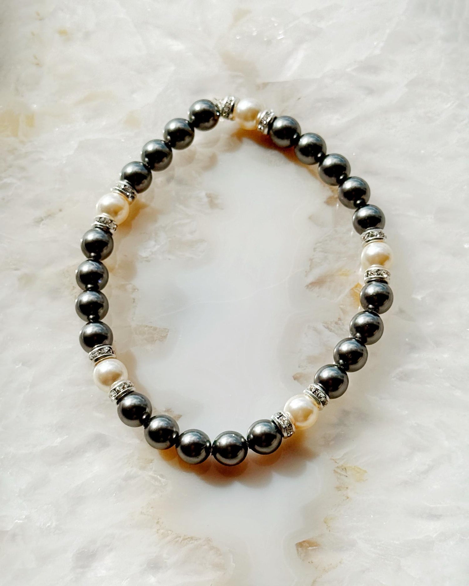 Jan Black Pearl Bracelet handcrafted in Canada with European crystal black pearls white pearls and crystal rondelles styled in an elegant flat lay