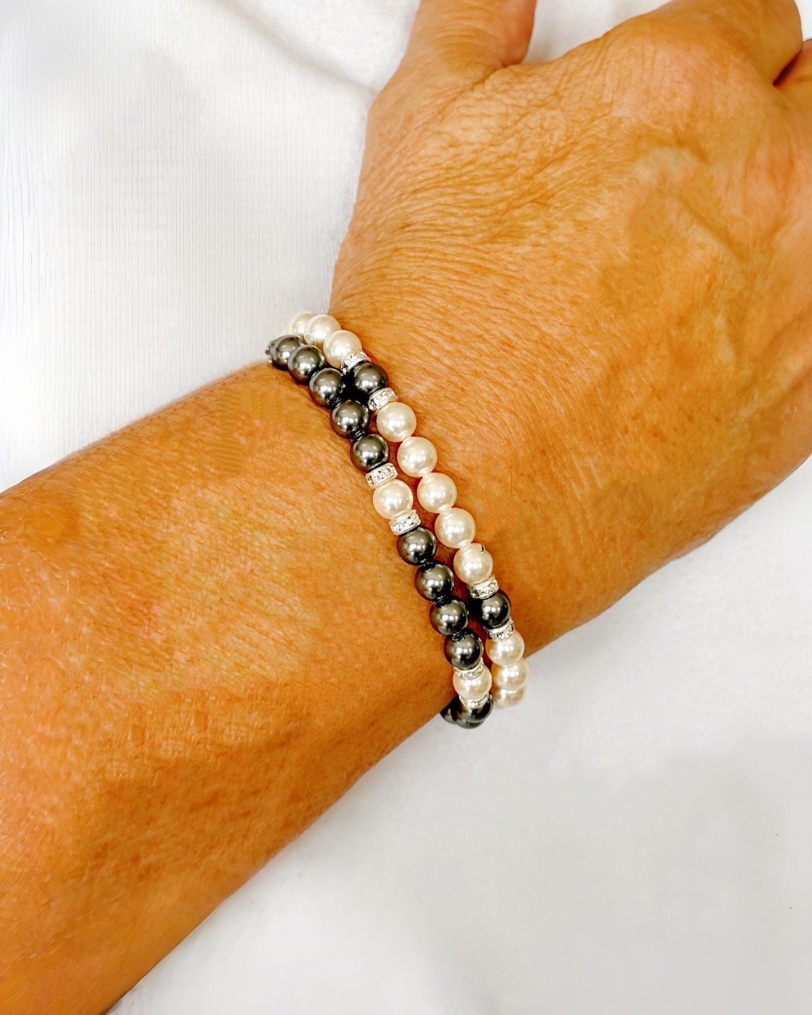 Model wearing the Juanita Pearl Stretch Bracelet stacked with the Jan Black Pearl Bracelet for a balanced, modern pearl styling