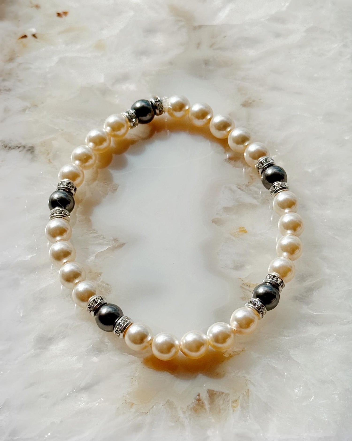 Elegant Juanita Pearl Stretch Bracelet showcasing luminous cream pearls accented with dark grey pearls and crystal rondelles
