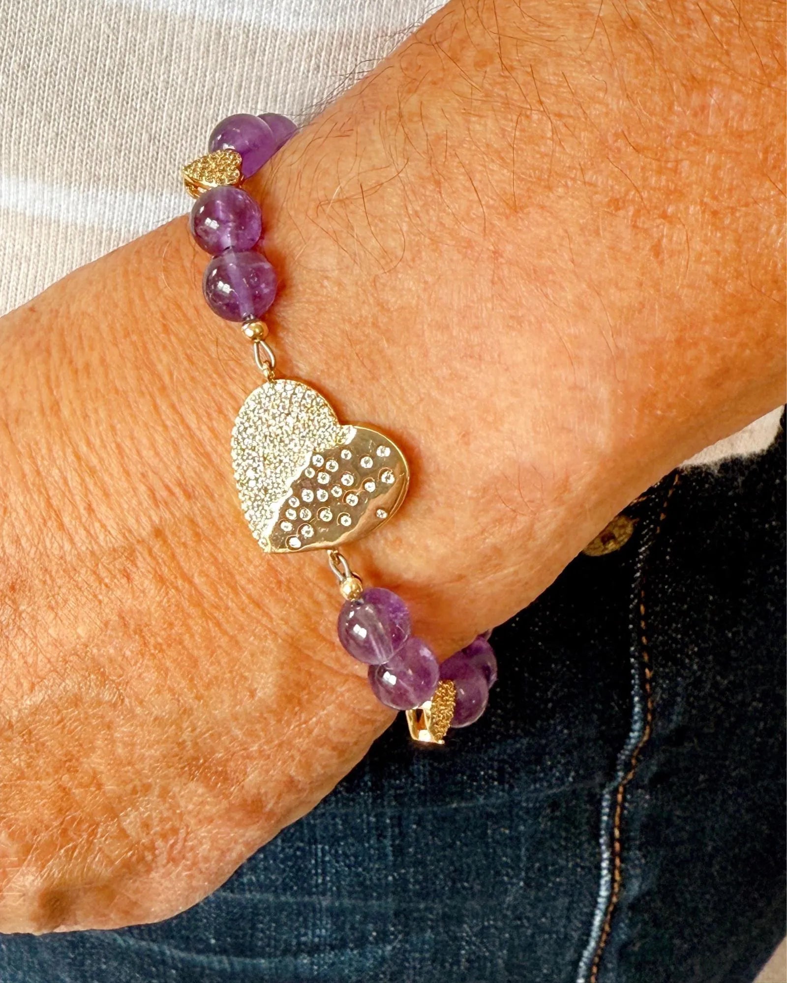 Close-up of Kalei amethyst stones and 14K gold micro-pave heart connector