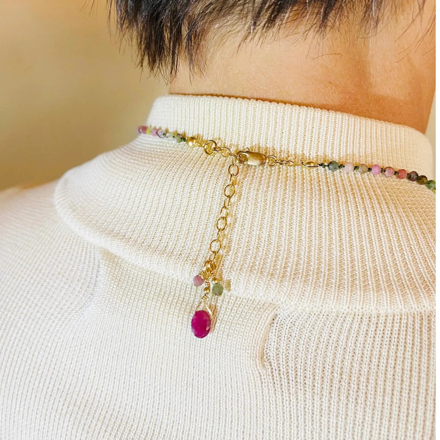 Close up view of the Layla Gemstone Necklace clasp and extension chain featuring coordinating tourmaline and ruby accents.