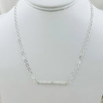 The Morganite Gemstone Bar Necklace displayed on a jewelry bust, emphasizing its balanced proportions and soft blush gemstone elegance.