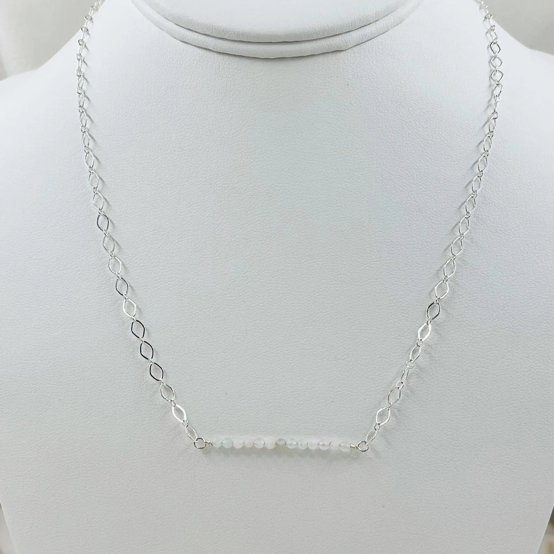 The Morganite Gemstone Bar Necklace displayed on a jewelry bust, emphasizing its balanced proportions and soft blush gemstone elegance.