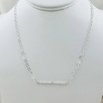 The Morganite Gemstone Bar Necklace displayed on a jewelry bust, emphasizing its balanced proportions and soft blush gemstone elegance.