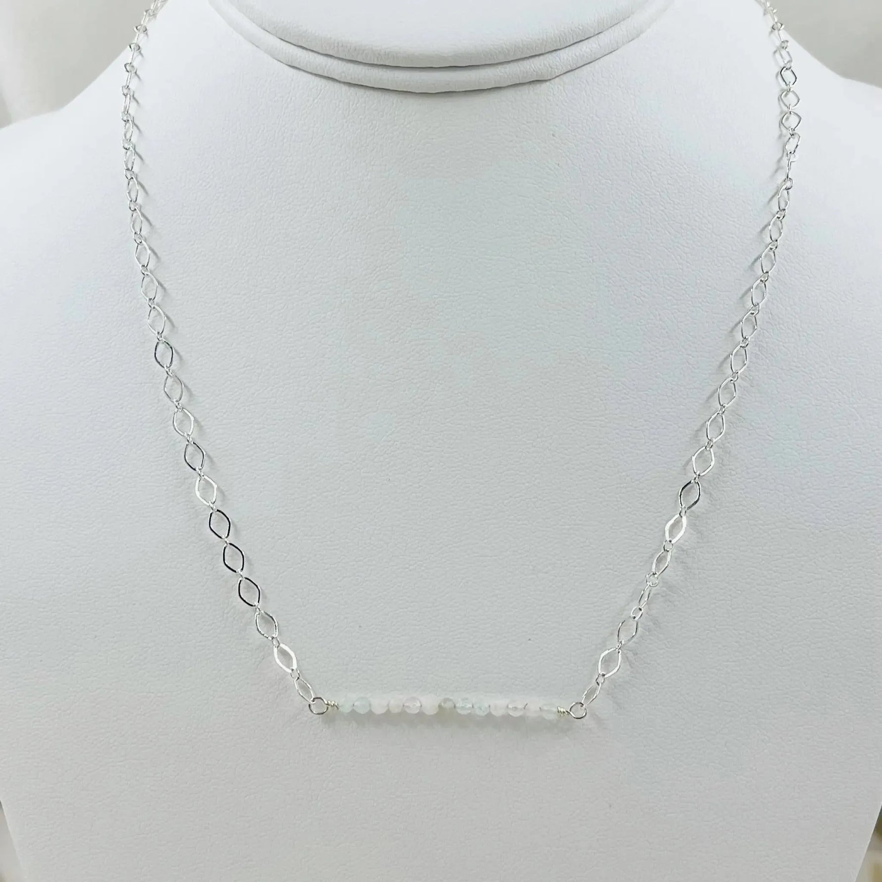 The Morganite Gemstone Bar Necklace displayed on a jewelry bust, emphasizing its balanced proportions and soft blush gemstone elegance.