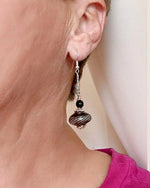 Model wearing the Venezia Murano Glass Earrings in sterling silver with black and silver Murano glass, shown as a lightweight elegant drop earring.