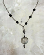 Close up detail of the Venezia Murano Glass Statement Necklace showcasing the handcrafted Murano glass pendant with black and silver patterning and crystal accents.