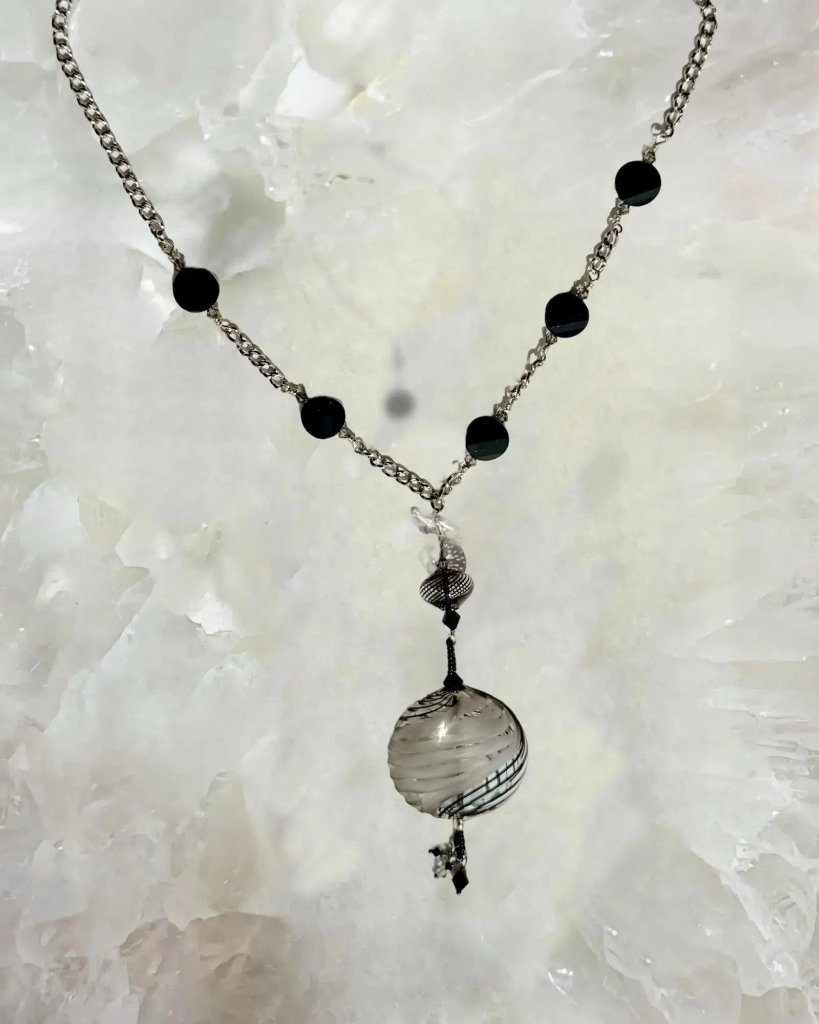 Close up detail of the Venezia Murano Glass Statement Necklace showcasing the handcrafted Murano glass pendant with black and silver patterning and crystal accents.