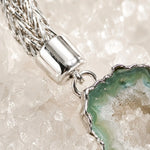 Close-up of the Ava bracelet highlighting the handwoven .999 fine silver weave, sterling silver end cap, and natural green agate druzy with crystalline texture.
