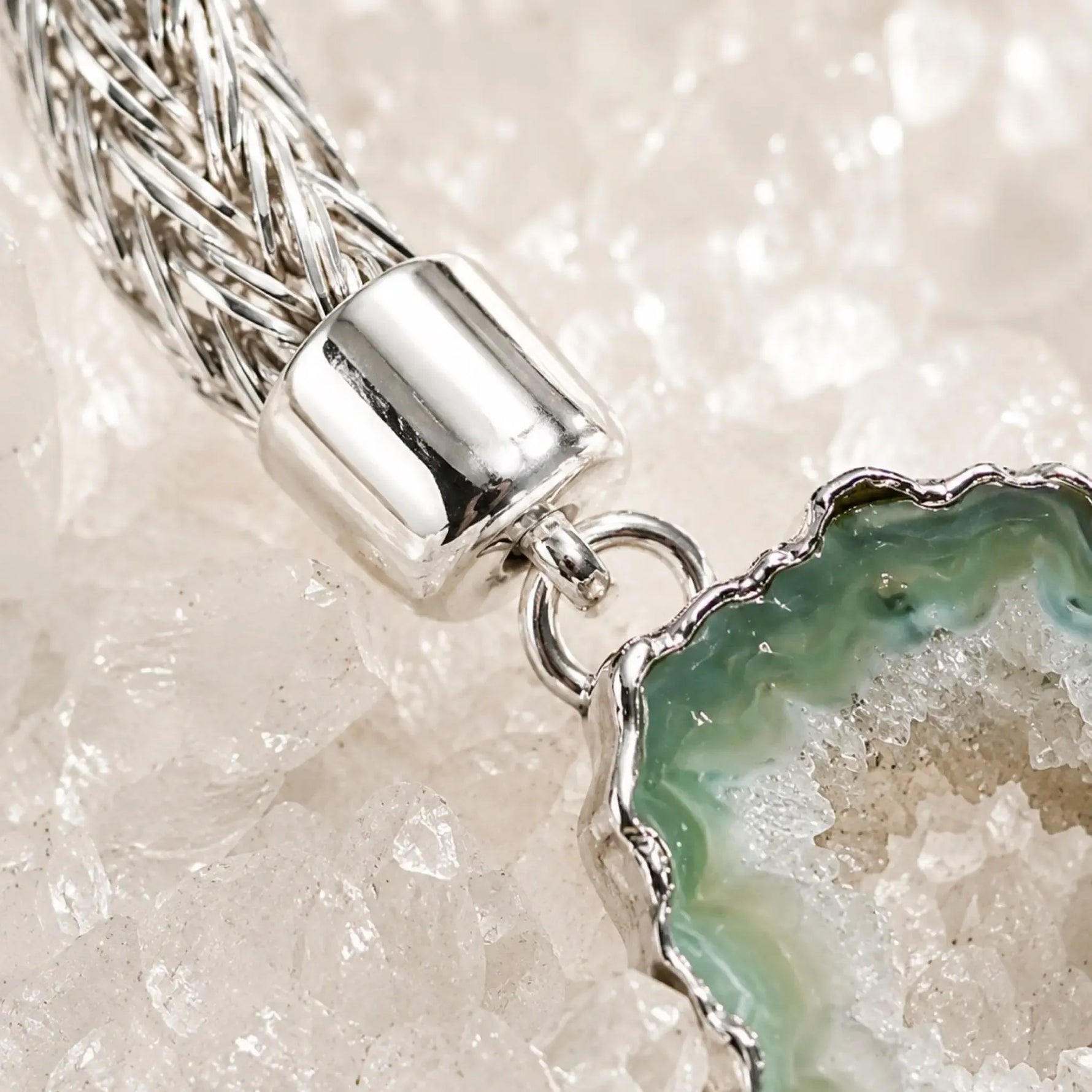 Close-up of the Ava bracelet highlighting the handwoven .999 fine silver weave, sterling silver end cap, and natural green agate druzy with crystalline texture.