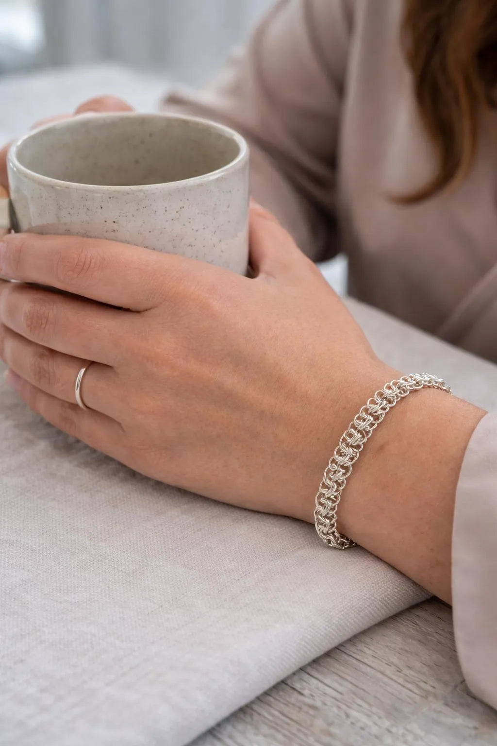 Avalon luxury sterling silver bracelet in Celtic Helm chainmaille, styled for everyday elegance with soft textures and timeless sophistication.