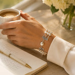Calla Swarovski® Crystal Pearl bracelet worn while enjoying morning coffee beside an open journal in soft natural window light.