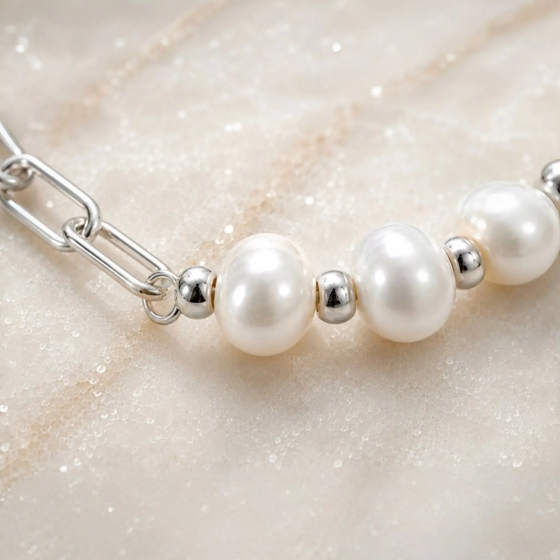 Macro detail of the Callie bracelet highlighting luminous 9–10 mm freshwater pearls, polished silver spacer beads and handcrafted construction.