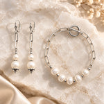 Callie freshwater pearl earrings with matching five-pearl bracelet styled on white quartz