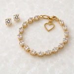 Capri Gold Crystal Tennis Bracelet displayed with matching crystal stud earrings on the signature Carabella white quartz slab for a coordinated jewellery set.