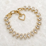 Capri Gold Crystal Tennis Bracelet handcrafted in Canada featuring marquise-cut European crystals in a champagne gold finish displayed on the Carabella white quartz slab.