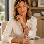 Woman wearing the Capri Multi-Color Crystal Tennis Bracelet with an ivory blouse in a refined professional setting, demonstrating elegant everyday style.