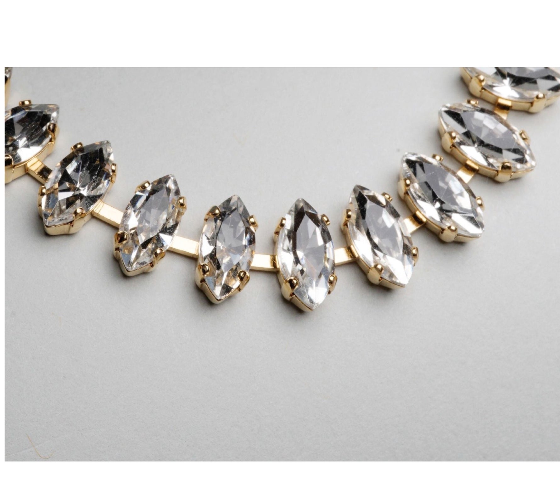 Close-up of marquise-cut crystal stones in the Capri tennis bracelet, showcasing brilliant sparkle and refined gold settings