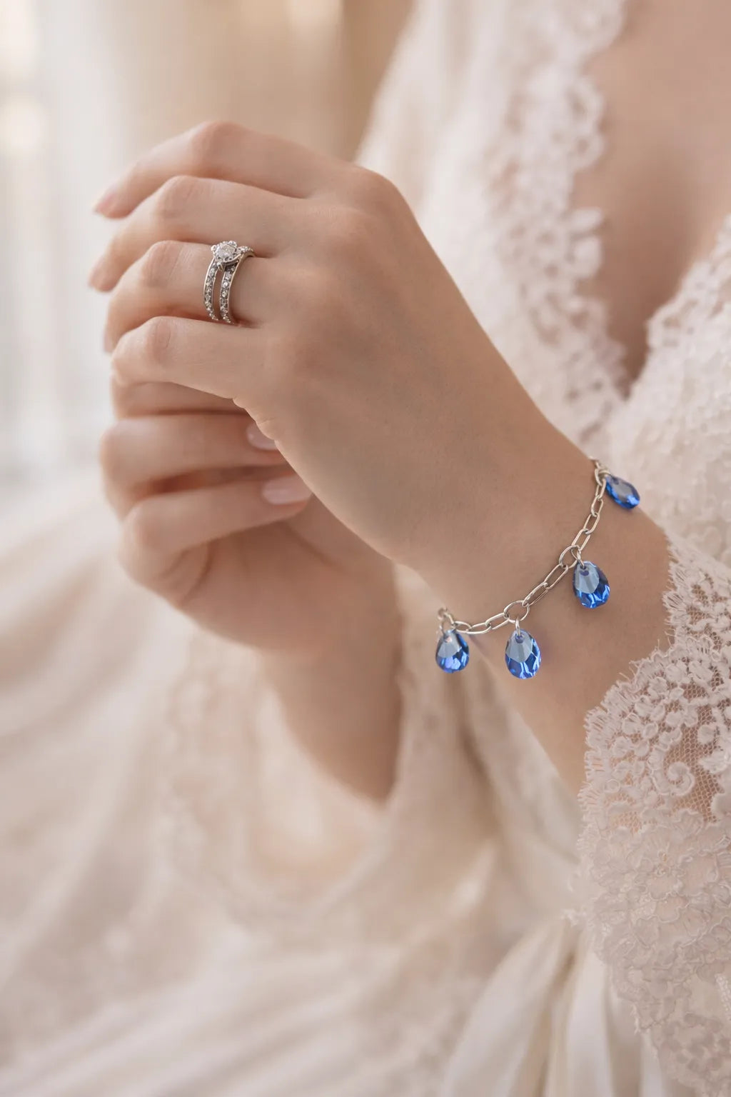 Blue crystal charm bracelet styled with bridal lace sleeve and diamond ring