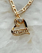 Close-up of the Eternal Love heart pendant engraved with “mom,” featuring cubic zirconia sparkle and gold-plated warmth in a refined Carabella by Cheryl luxury style.