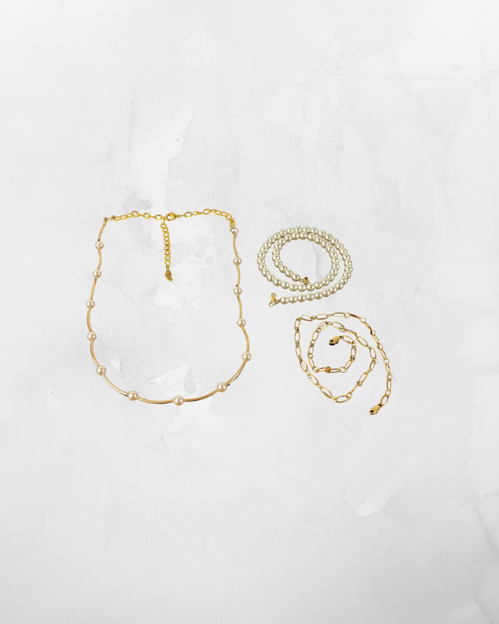 Cassia pearl necklace components arranged in flat lay showing layered pearl strand and gold chain elements, sophisticated pearl jewelry design