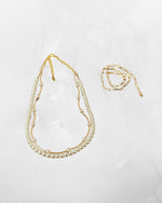 Side view of Cassia pearl necklace showing Austrian crystal pearl strand and gold chain layering, modern classic pearl jewelry