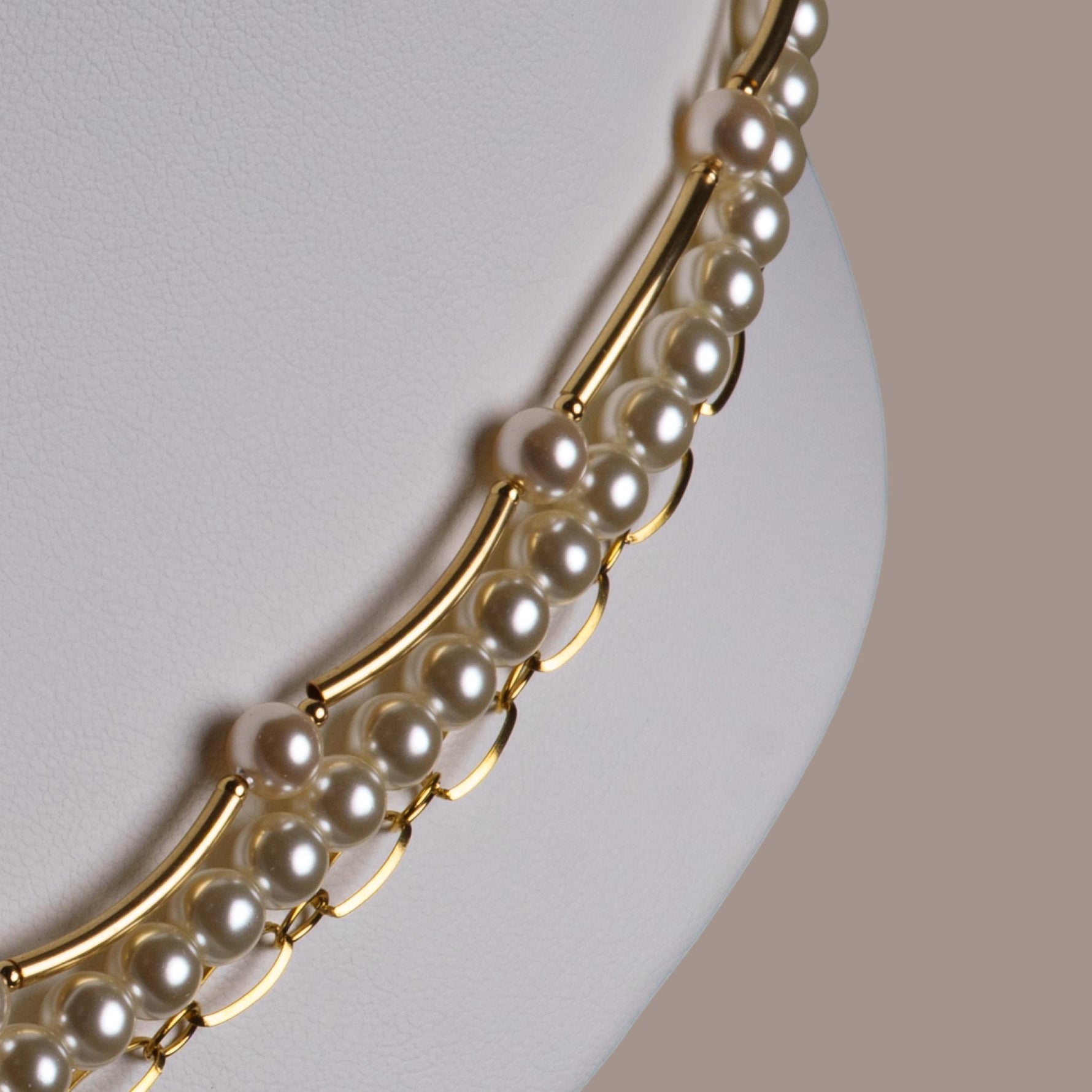 Close up of Cassia pearl necklace highlighting Austrian crystal pearls and gold bar accents, refined pearl jewelry with modern elegance