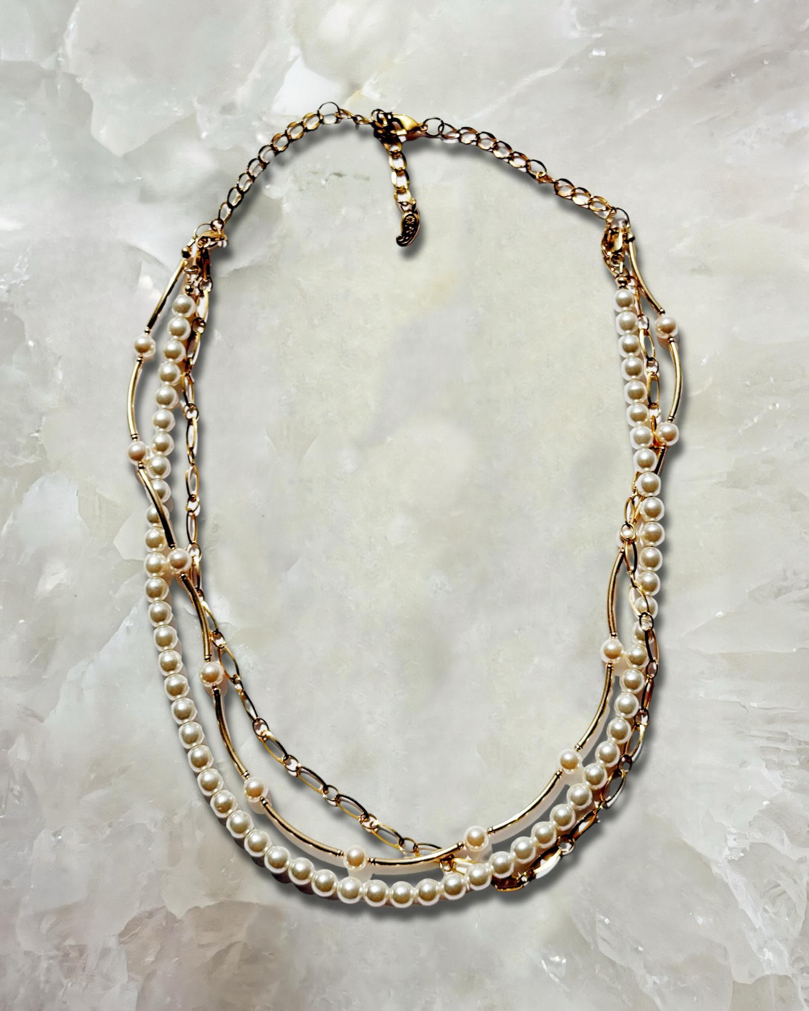 Cassia pearl necklace with Austrian crystal pearls and gold accents laid flat, an elegant pearl necklace for women featuring a timeless layered design