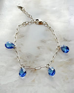 Ella Sapphire Crystal Drop Bracelet with sapphire blue European crystal drops and sterling silver plated paperclip chain, handcrafted in Canada by Carabella by Cheryl