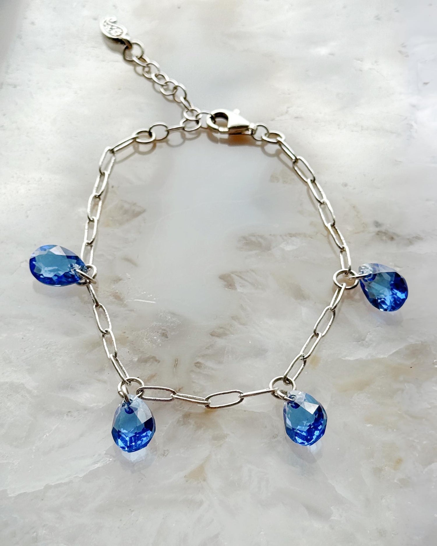 Ella Sapphire Crystal Drop Bracelet with sapphire blue European crystal drops and sterling silver plated paperclip chain, handcrafted in Canada by Carabella by Cheryl