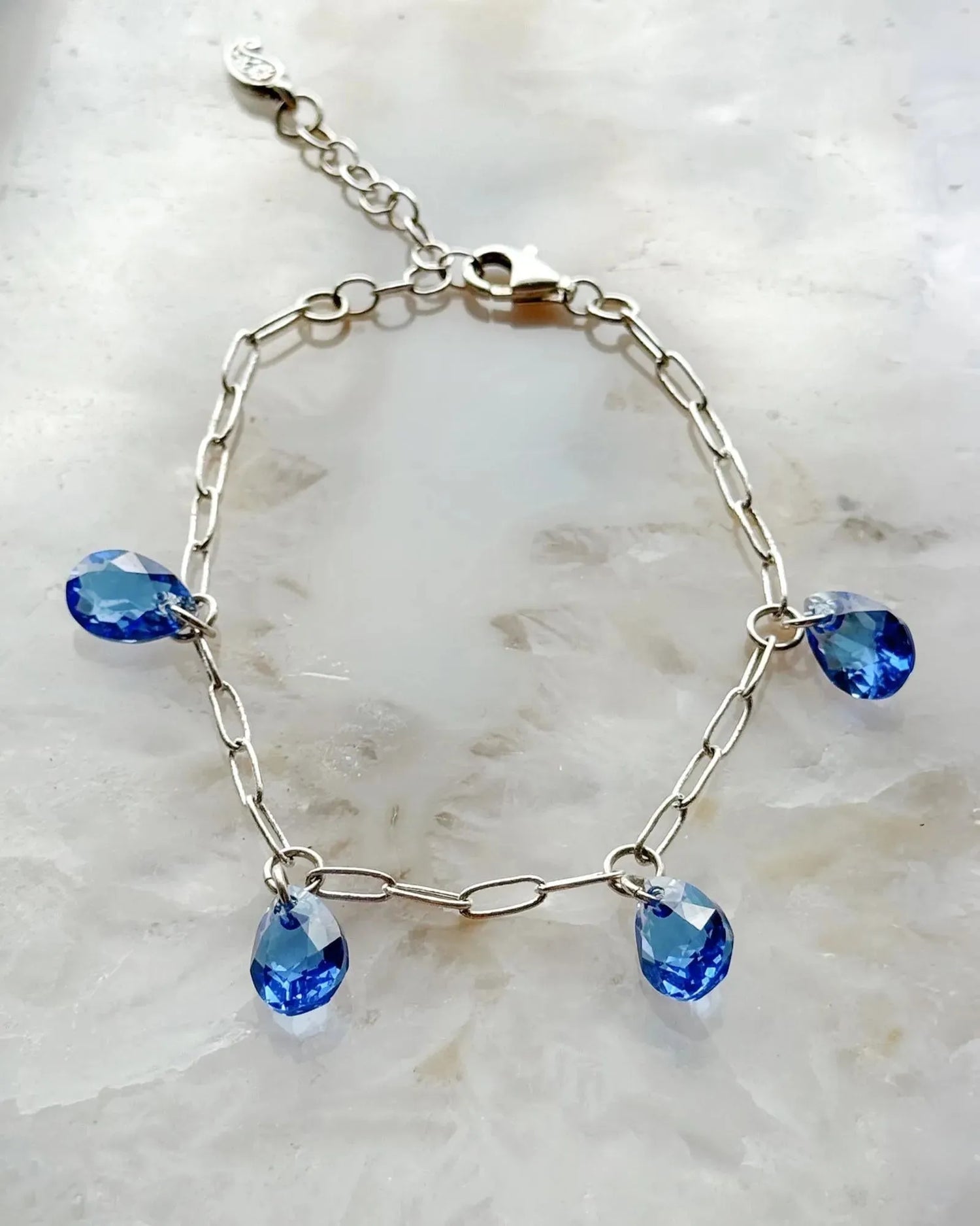 Ella Sapphire Crystal Drop Bracelet with sapphire blue European crystal drops and sterling silver plated paperclip chain, handcrafted in Canada by Carabella by Cheryl