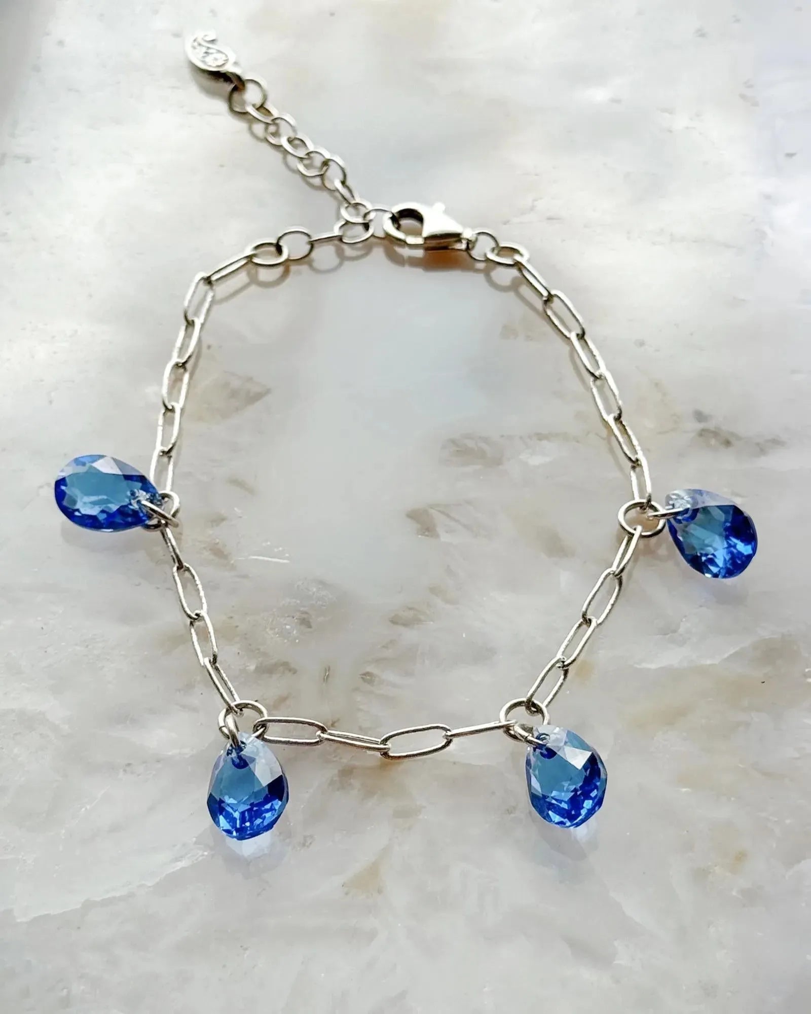 Ella Sapphire Crystal Drop Bracelet with sapphire blue European crystal drops and sterling silver plated paperclip chain, handcrafted in Canada by Carabella by Cheryl