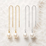 Gold and sterling silver threader pearl earrings displayed together for metal comparison on white quartz.