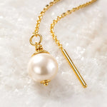 Macro detail of handcrafted gold threader pearl earrings showing Swarovski® Crystal Pearl, fine chain and polished gold finish.