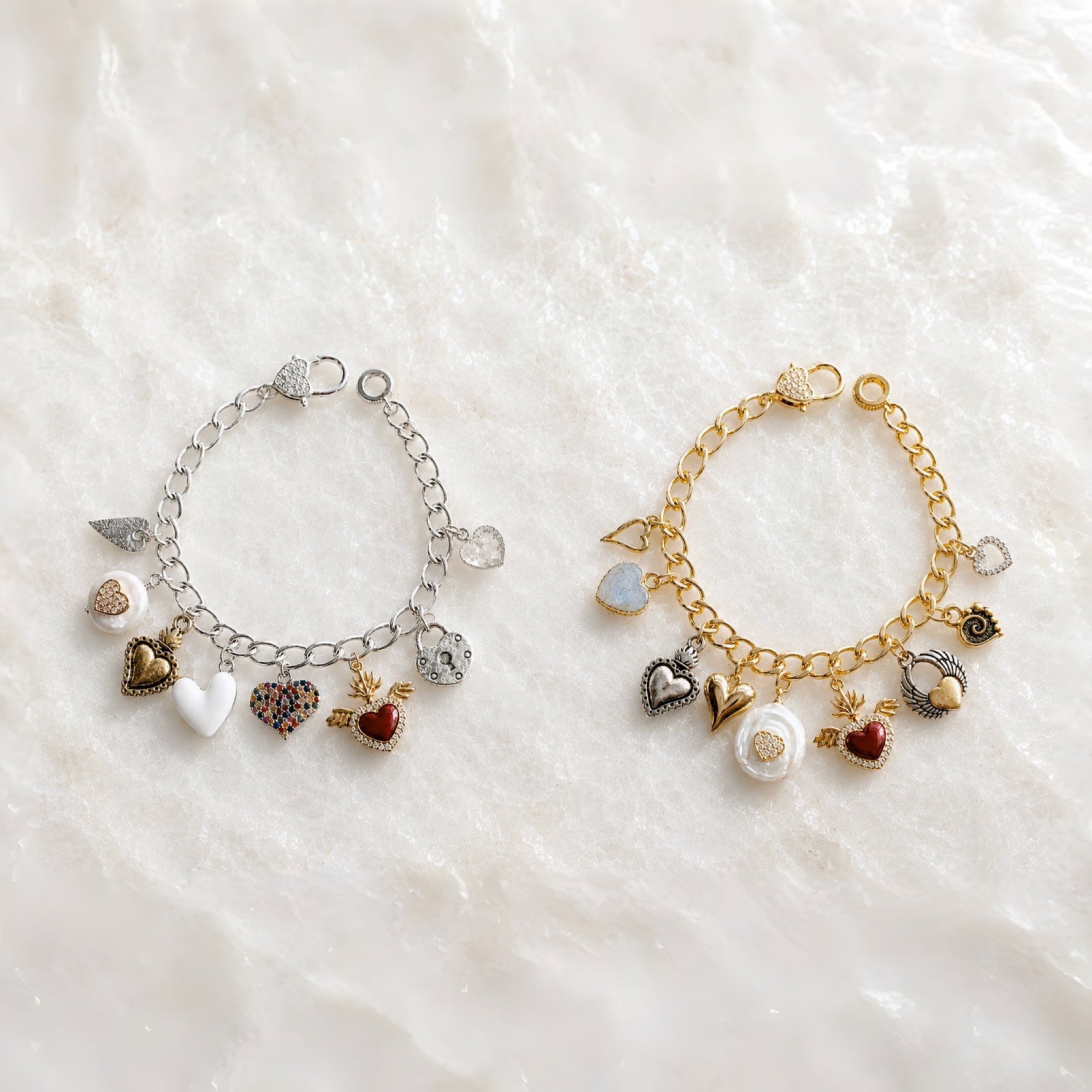 Esme Charm Bracelet Collection shown in both silver and gold finishes on white quartz, highlighting handcrafted heart charms and signature mixed-metal styling.