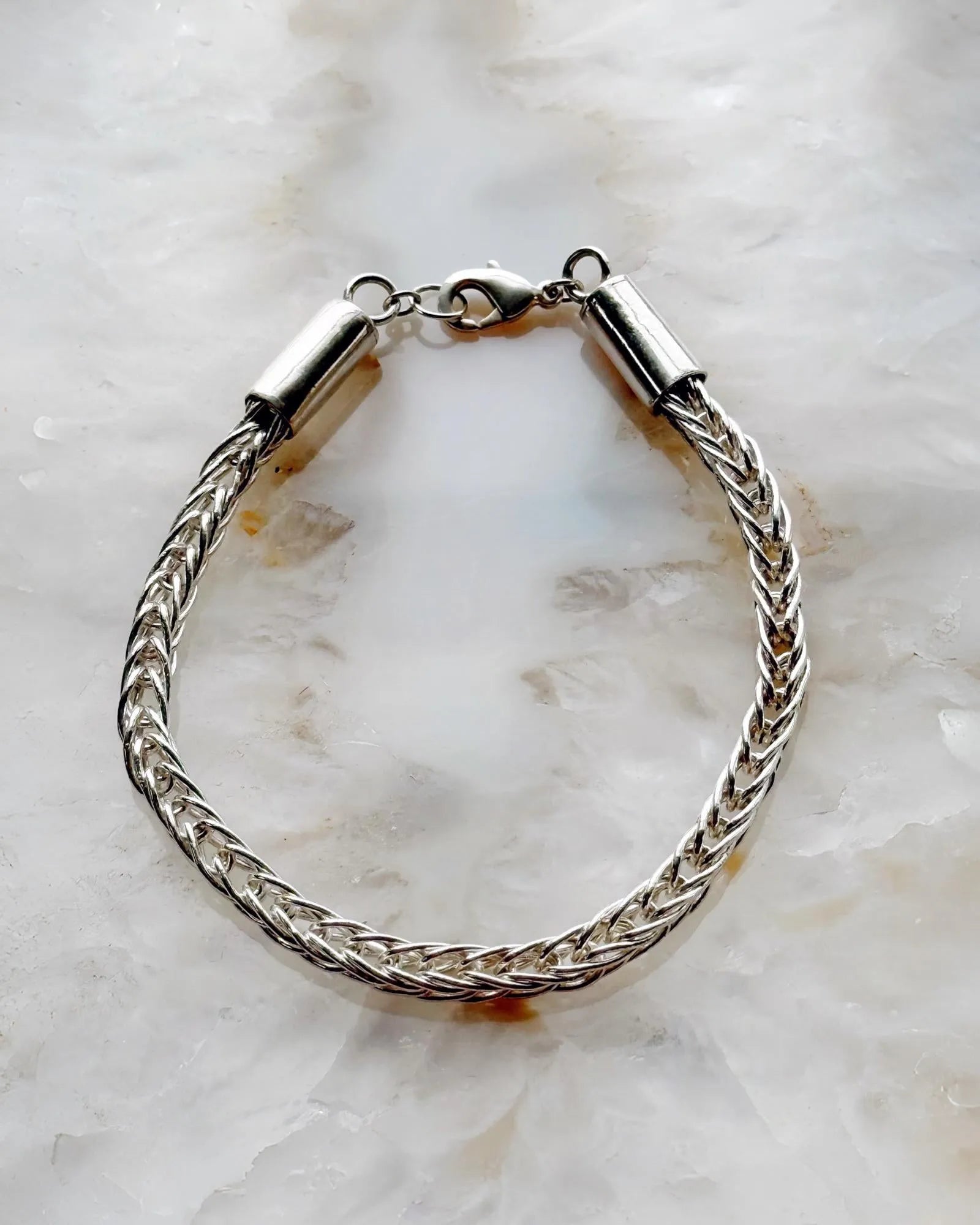 Close-up of the Evelyn Fine Silver Bracelet showing hand-woven .999 fine silver links with a sterling clasp—each link cut, fused, and woven by hand for exceptional craftsmanship.